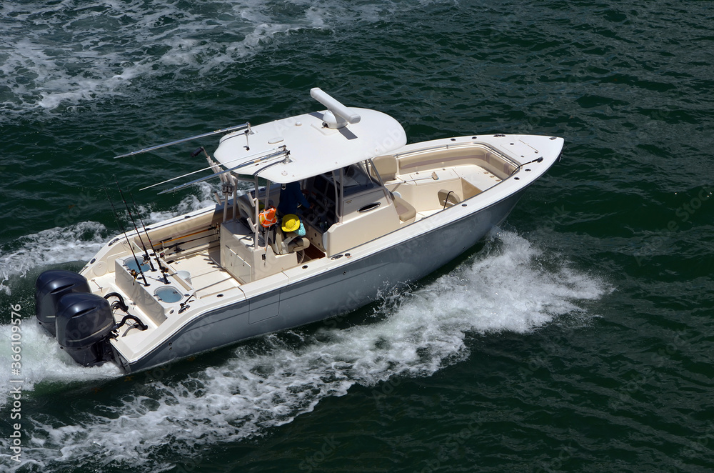 Center console fishing boat running across open water